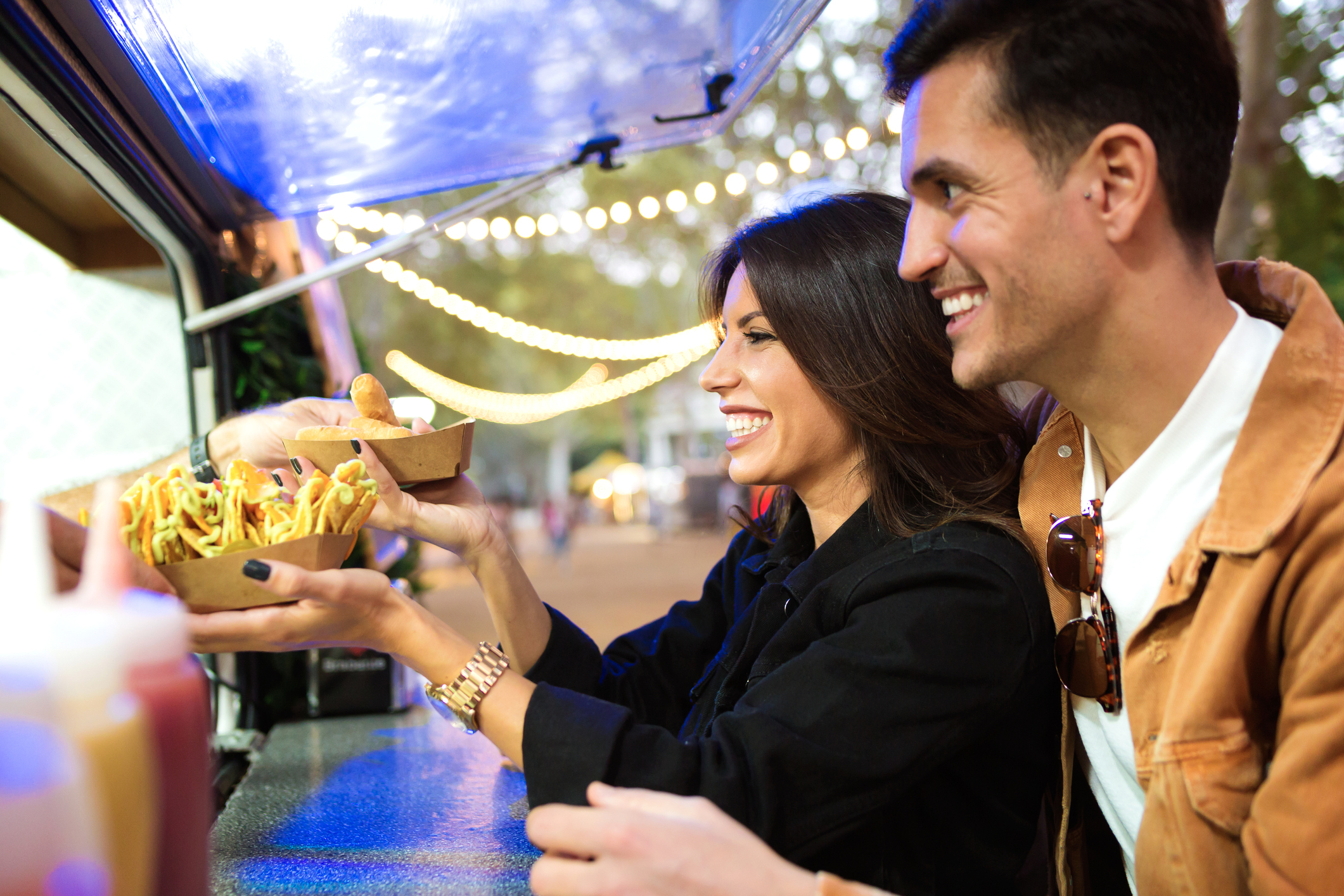 Couple getting food from food truck