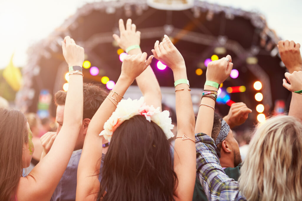 Audience with hands in the air at a music festival