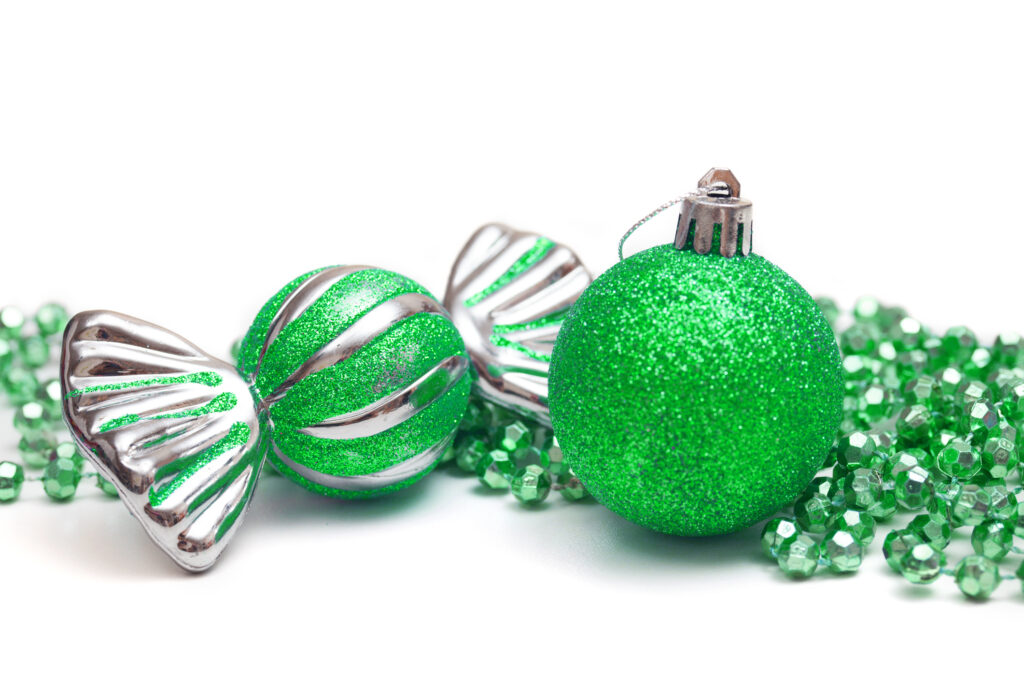 green Christmas ornaments on white background